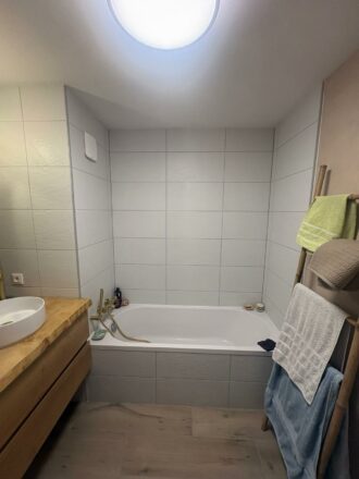 vue baignoire et plan de travail bois massif sur mesure avec lasure epoxy réalisé par Eau et Design pour cette rénovation salle de bain